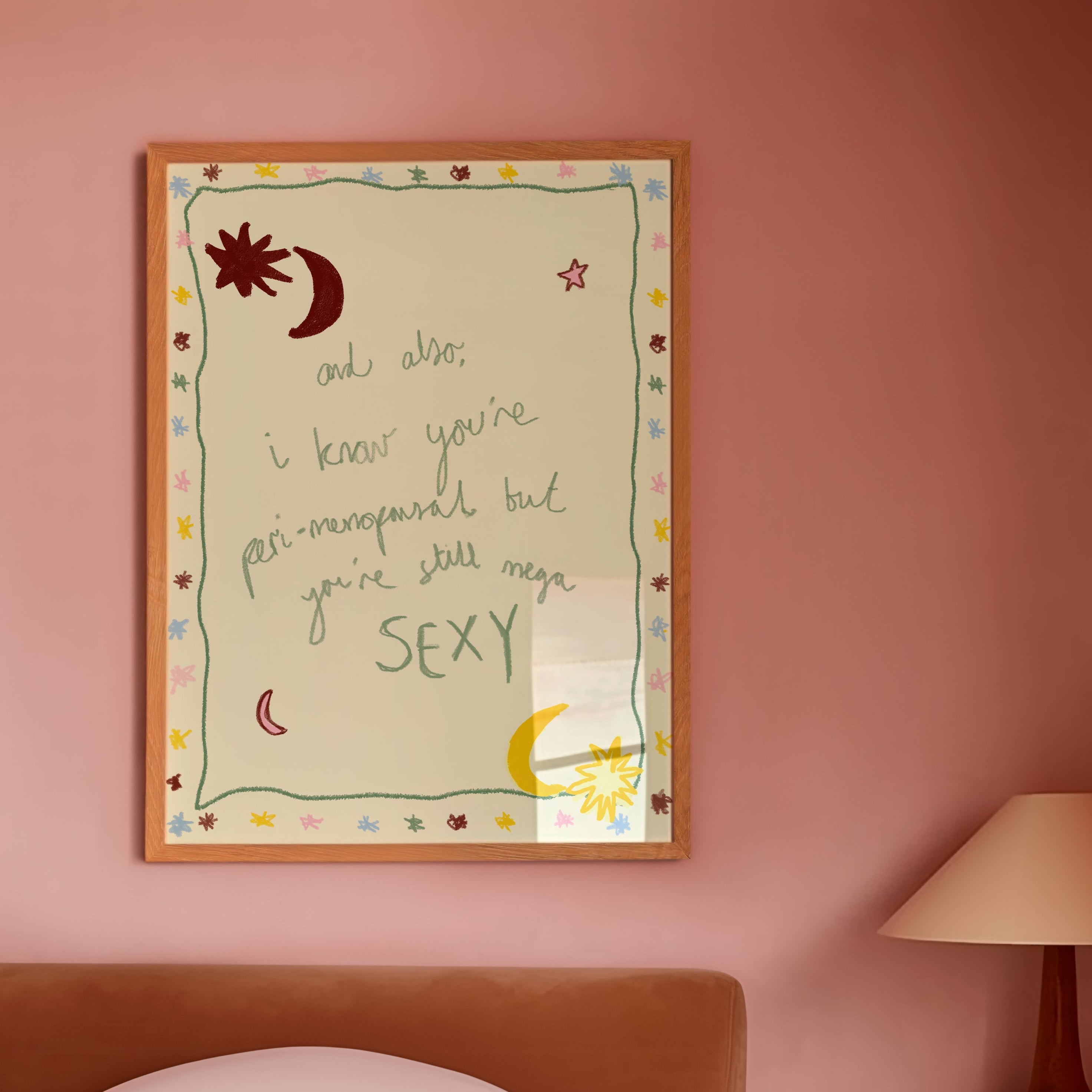 Mutli coloured 'you're still sexy' poster in frame in pink bedroom
