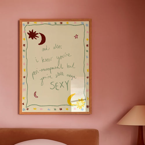 Mutli coloured 'you're still sexy' poster in frame in pink bedroom