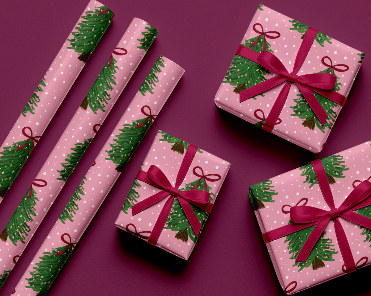 Pink gift boxes with green tree patterns and red ribbons on a purple background