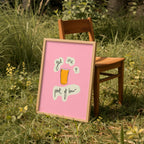 Framed pink sign with a graphic and text in a grassy outdoor setting