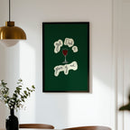 Framed artwork on a wall above a dining table with chairs.
