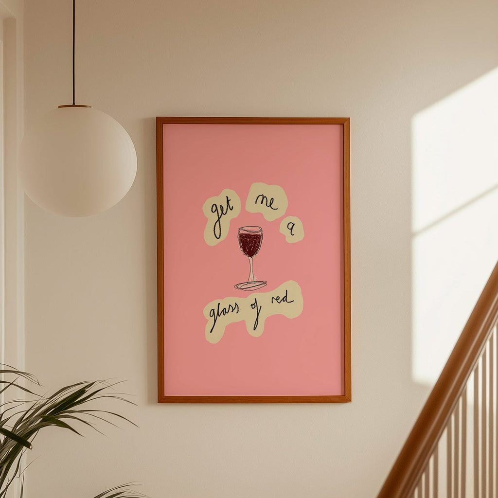 Framed artwork with text and a glass of red wine on a wall above a staircase.