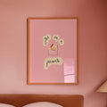 Pink bedroom with framed artwork 'get me a picante' on the wall and a lamp on a nightstand.