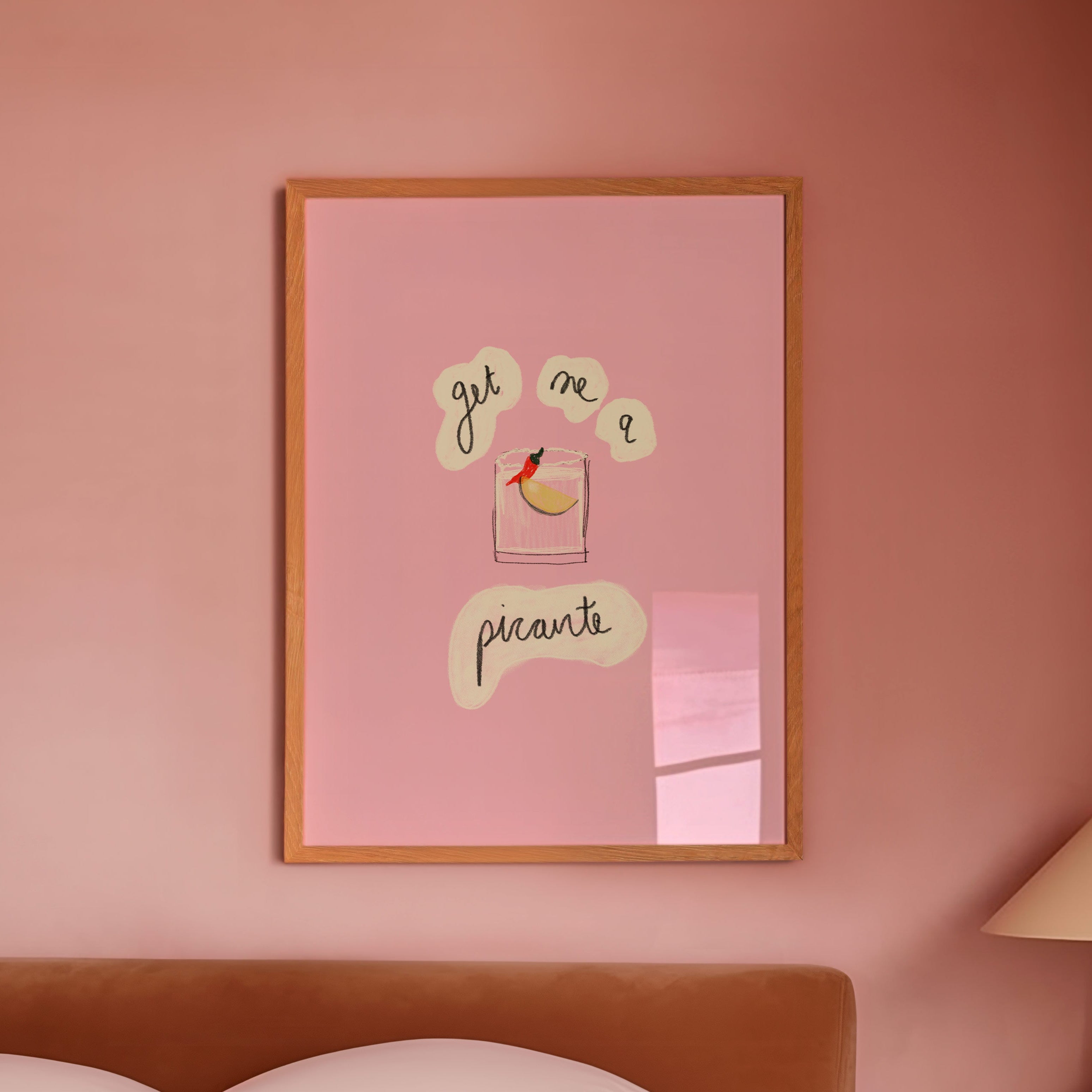 Pink bedroom with framed artwork 'get me a picante' on the wall and a lamp on a nightstand.