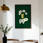 Framed artwork on a wall above a dining table with chairs.