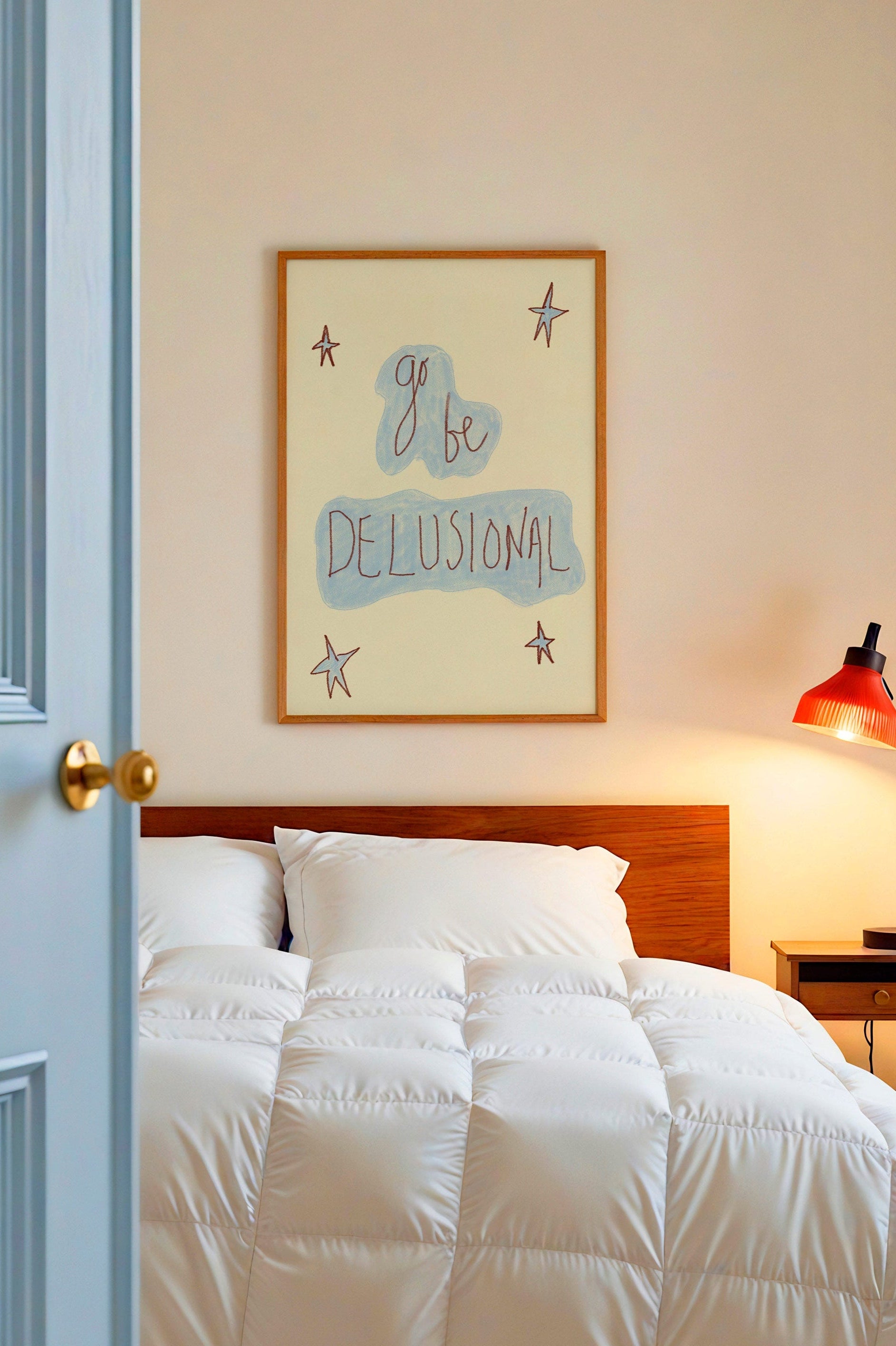 Bedroom with white bedding, wooden headboard, and framed artwork on wall.