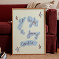 Framed artwork with text and star designs on a living room floor.