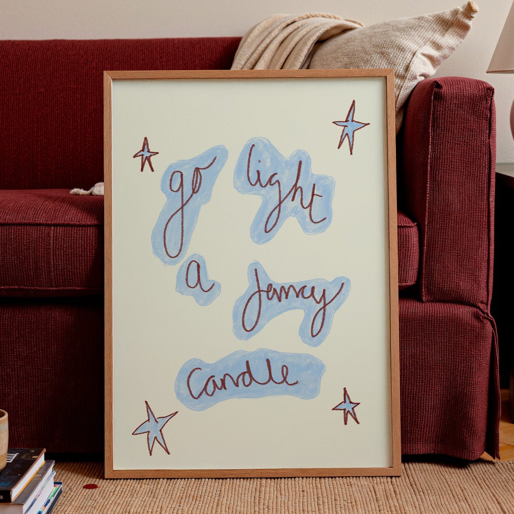 Framed artwork with text and star designs on a living room floor.