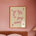 Bedroom with pink walls, a bed, and a lamp on a nightstand.