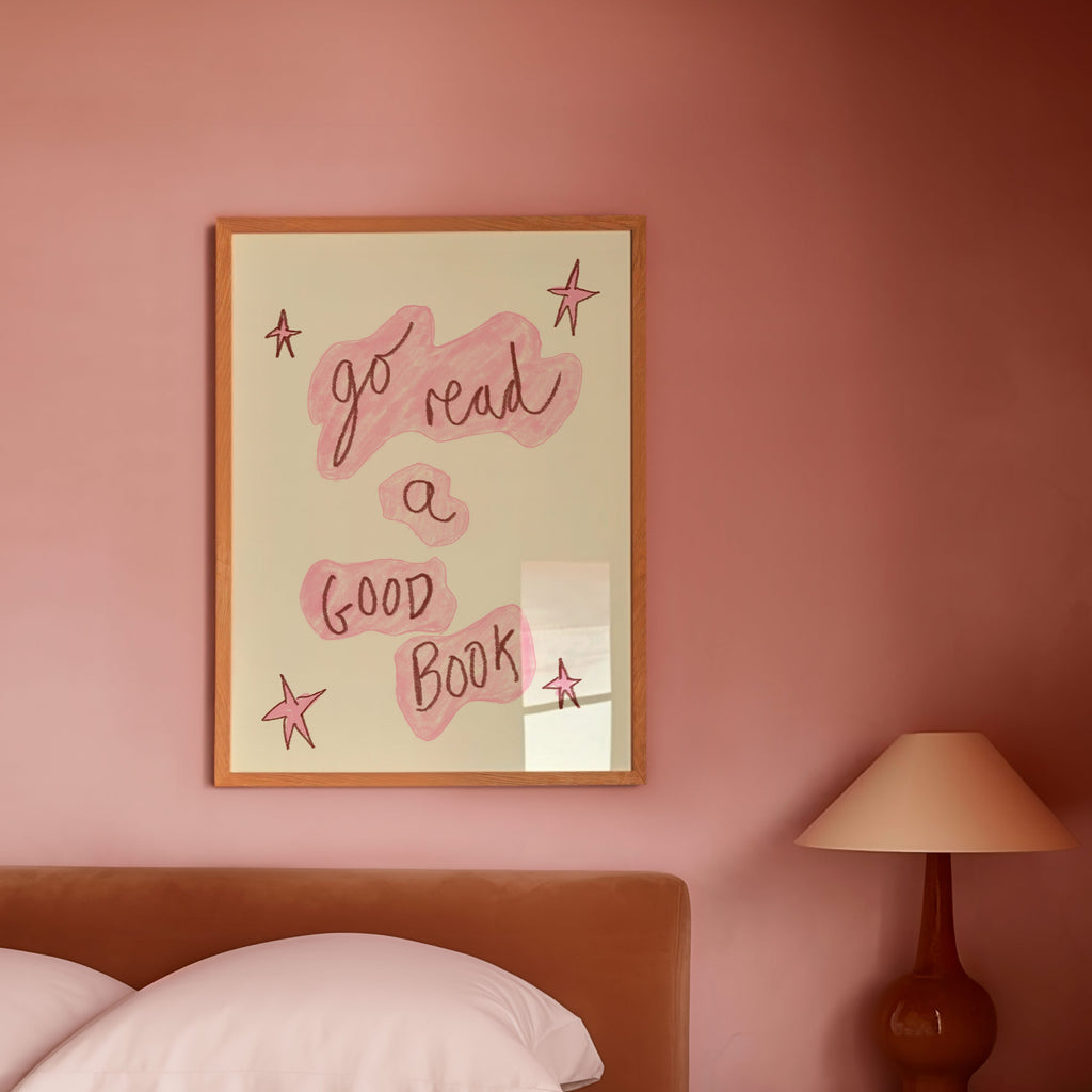 Bedroom with pink walls, a bed, and a framed quote on the wall.