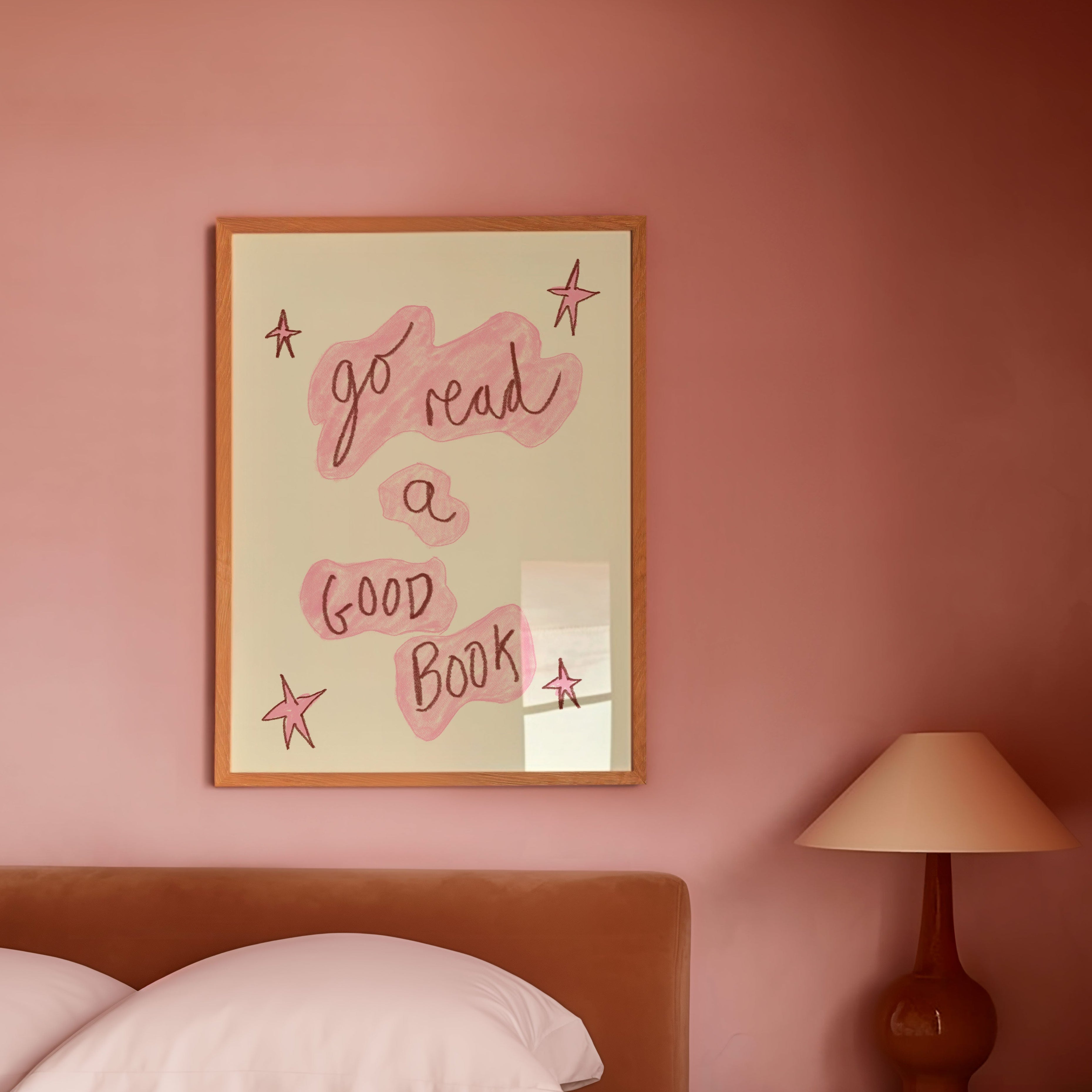 Bedroom with pink walls, a bed, and a framed quote on the wall.