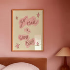 Bedroom with pink walls, a bed, and a framed quote on the wall.