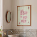 Bathroom interior with a sink, mirror, and framed quote on the wall.