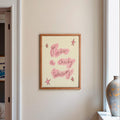 Frame on wall in kitchen with words 'go order a cheeky takeaway' in red and cream