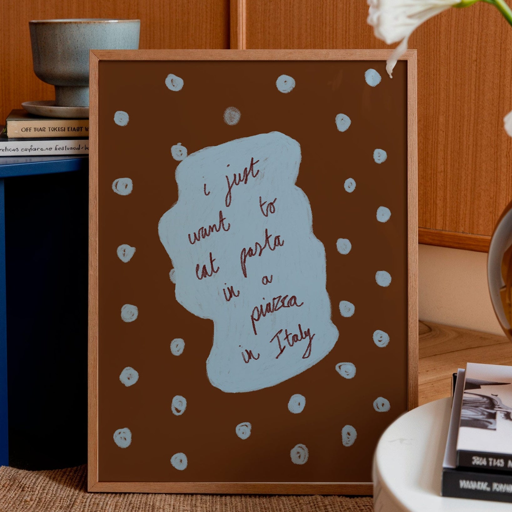 Decorative framed print with text on a table in a home setting