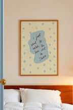 Bedroom with white bedding, wooden headboard, and framed artwork on the wall.