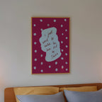 Bedroom with a bed, nightstands, and wall art