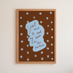Framed artwork with text 'I just want to read my book in the sunshine' on a brown background with white polka dots.