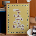 Yellow motivational print to be who you are in a frame in a living room setting
