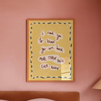 Bedroom with a pink wall, framed artwork, and a lamp.