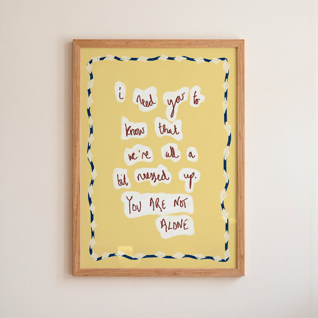 Framed artwork with motivational quote on a yellow background