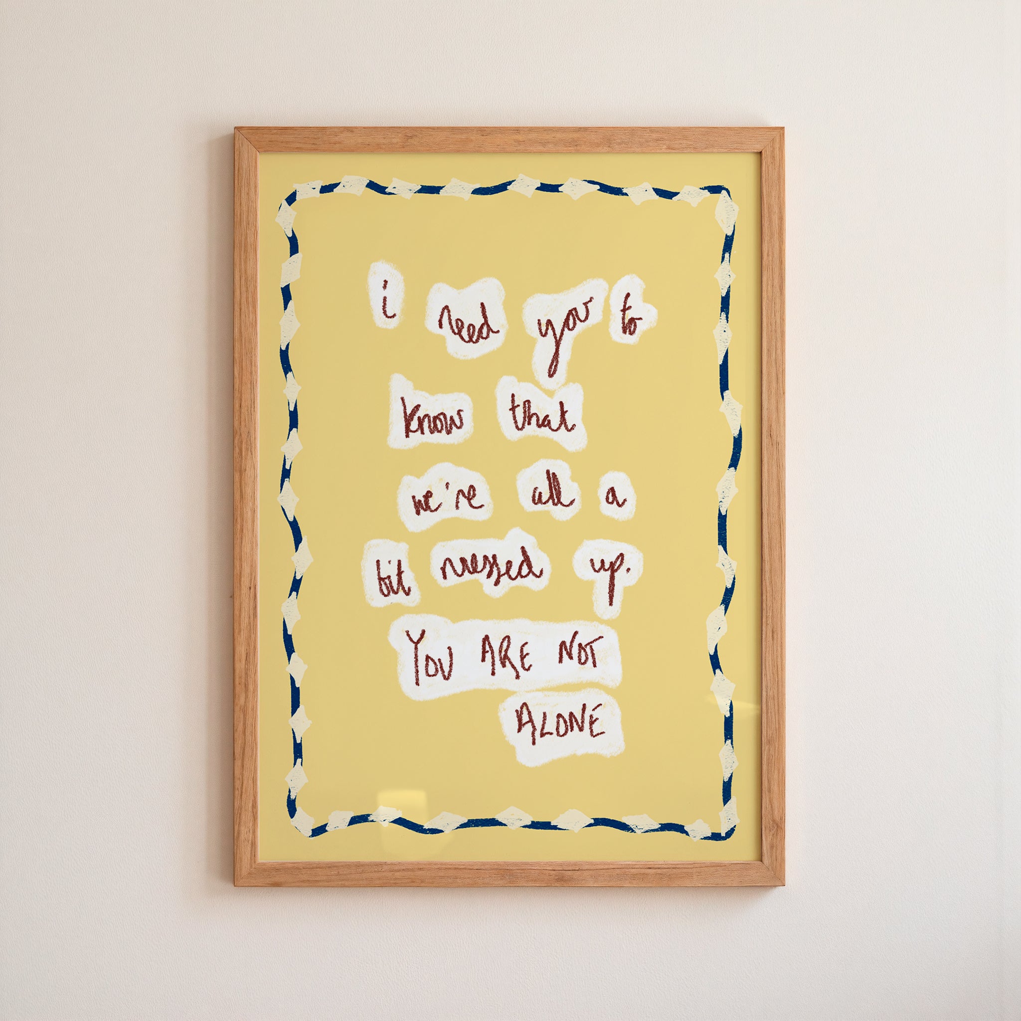 Framed artwork with motivational quote on a yellow background