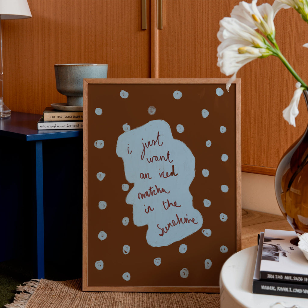 Decorative framed print with text and polka dots in a home setting