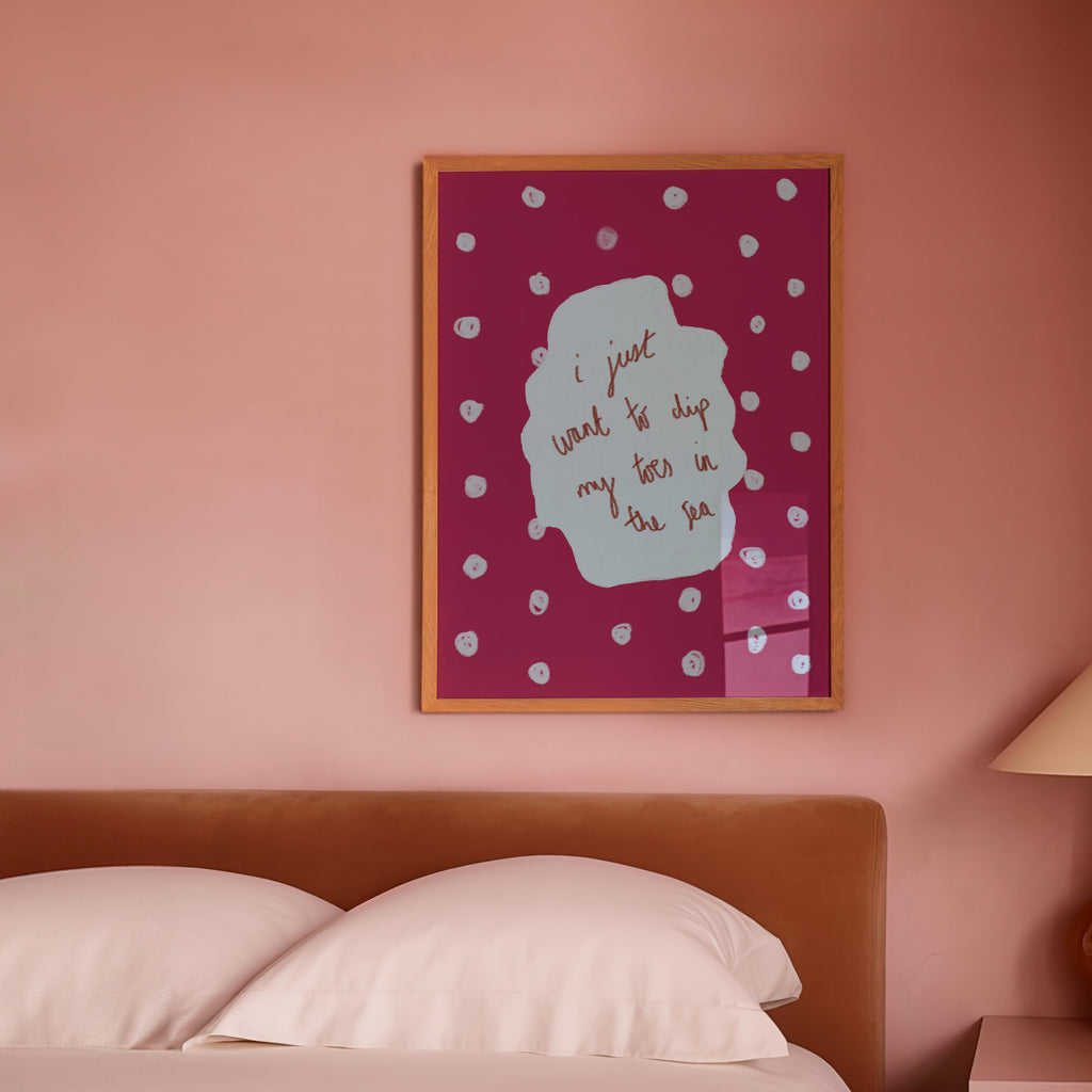 Bedroom with pink walls, a bed, and a lamp on a nightstand.