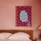 Bedroom with pink walls, a bed, and a lamp on a nightstand.